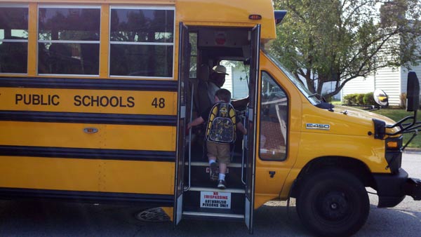 Atticus getting on his first schoolbus.